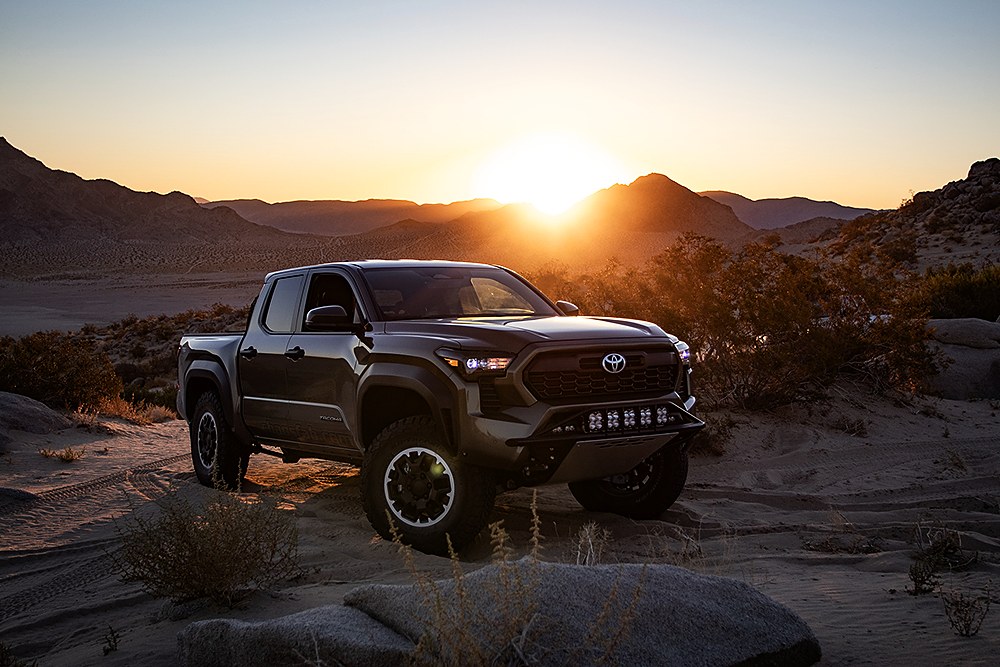 Placeholder photo: accessorized fourth-generation Tacoma in the desert at sunrise